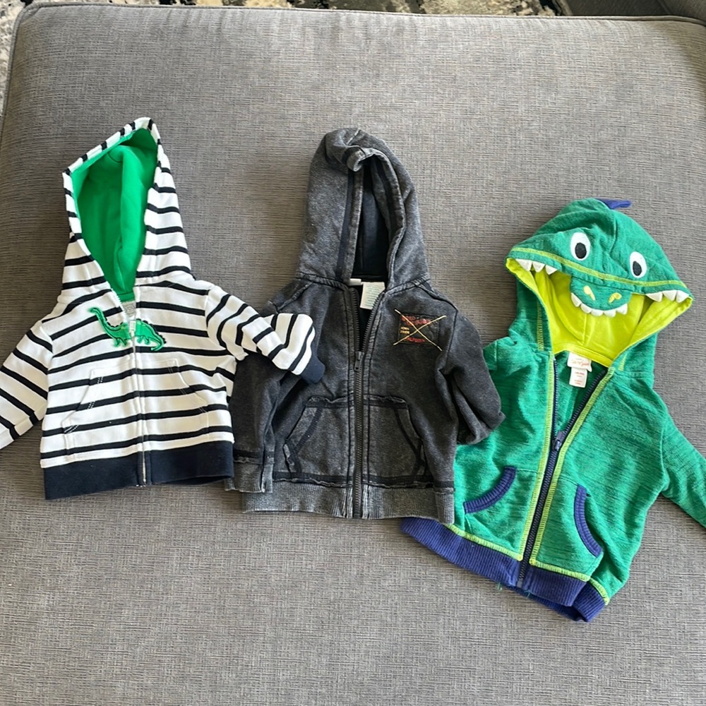 Three zip up hoodies in varying sizes